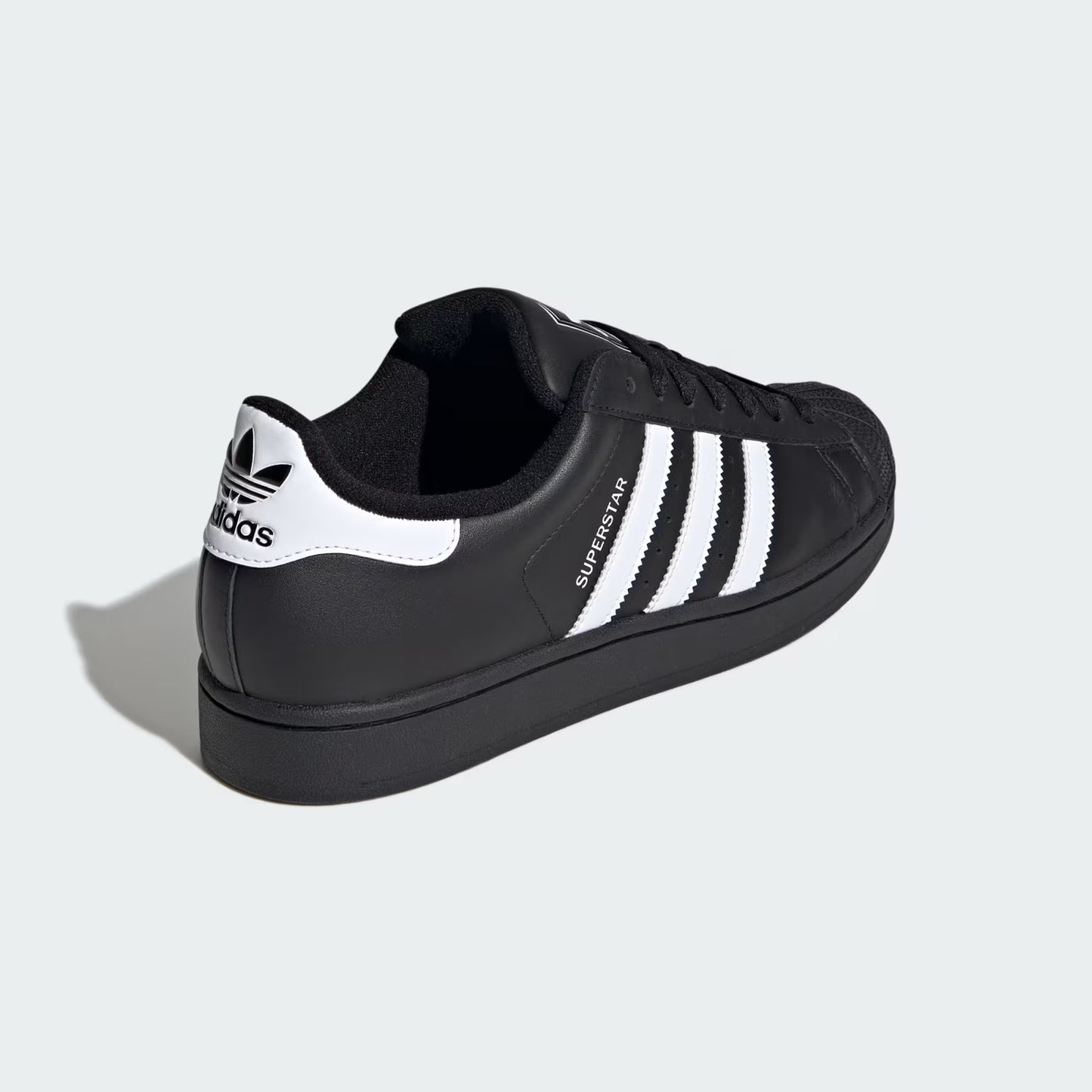 Rear three-quarter view of adidas Superstar II Shoes in core black highlighting heel tab and textured rubber outsole