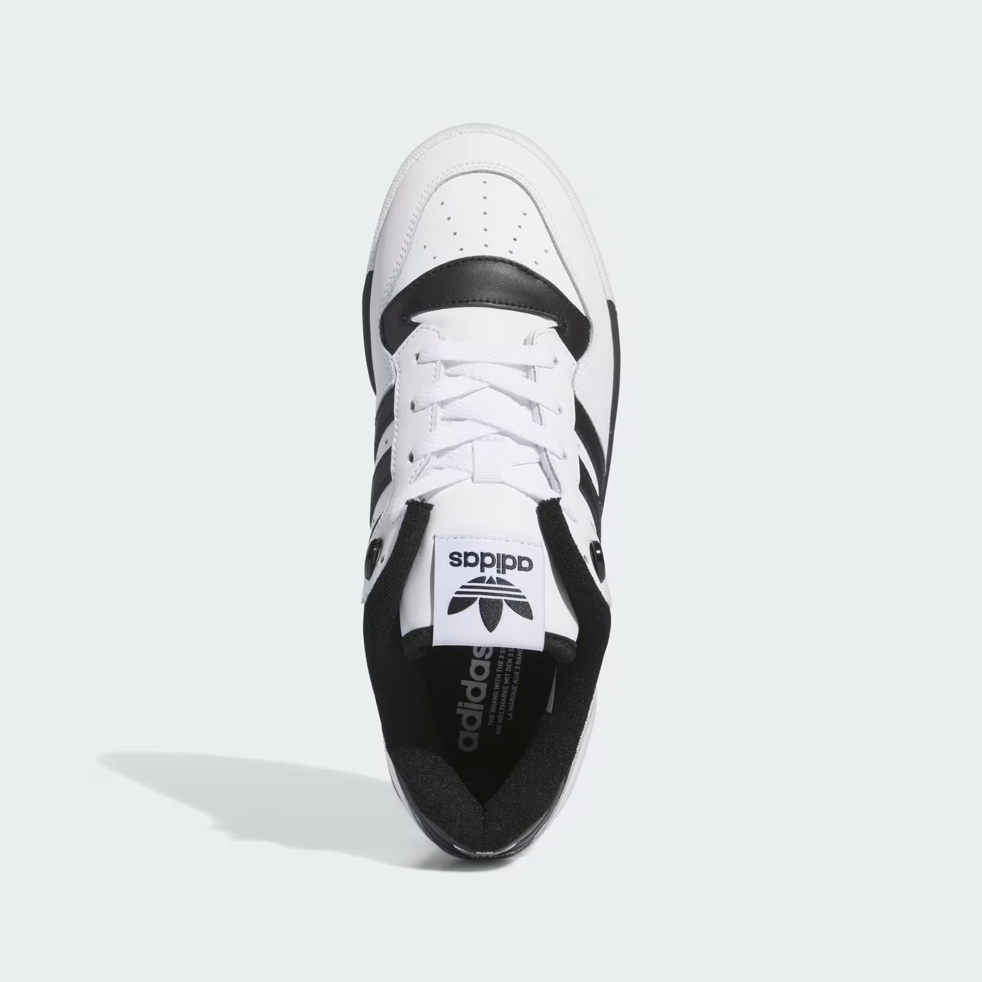 Adidas Rivalry Low Shoes White Black IG1474 three-quarter front view showing lace closure and terry lining