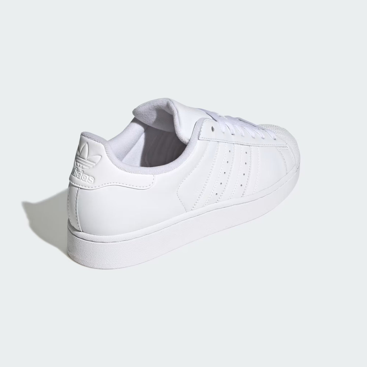 Rear three-quarter view of adidas Superstar II Shoes in cloud white highlighting heel tab and textured rubber outsole